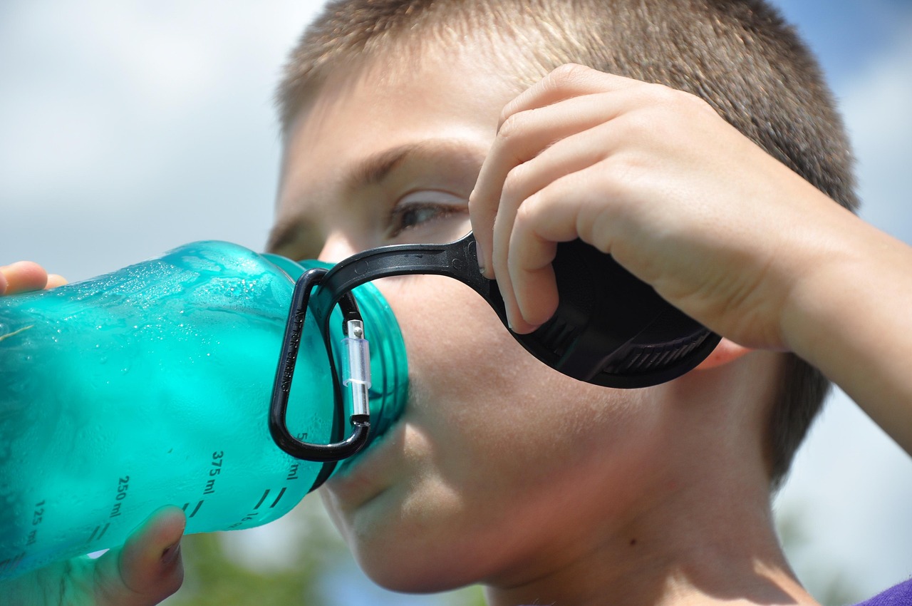 a kid drinking water